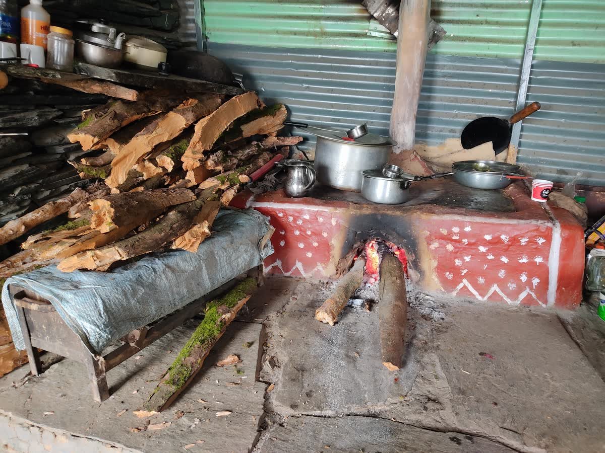 Meals cooking on the traditional wood chulha in the campsite kitchen