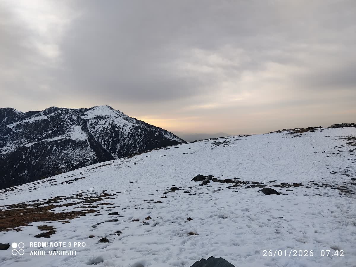 Sunset light over the snow-covered ridge above the Thatharana campsite