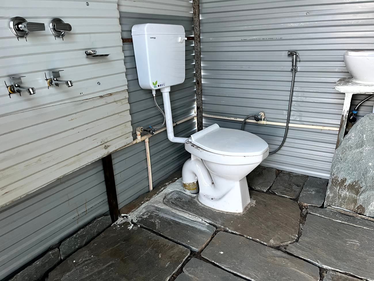 Clean attached washroom with a geyser, included with the Mudhouse Stay